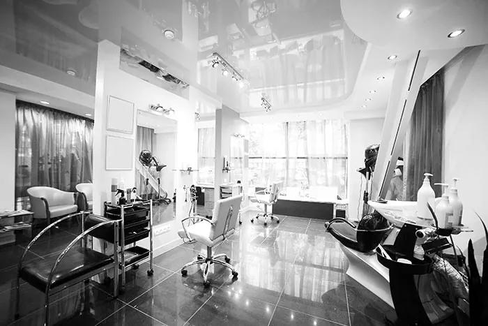 Beauty salon with styling stations, mirrors and polished floors