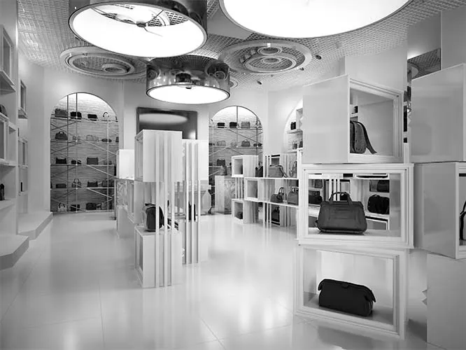 Accessories boutique with white display shelving and pendant lighting